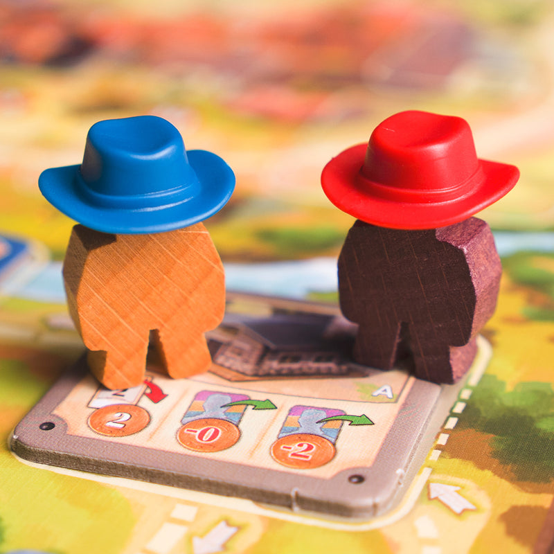 Load image into Gallery viewer, Great Western Trail Board Game - view of wood meeples wearing different colored cowboy hats.