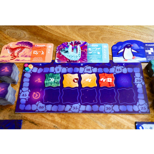 Night at the Zoo Board Game - Cheetah, Sloth, and Penguin animal boards shown. along with game board with score track. 