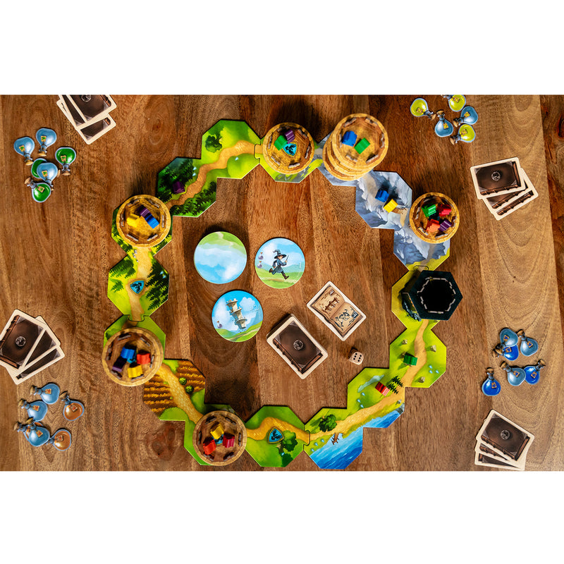 Load image into Gallery viewer, Wandering Towers Board Game - setup game shown on top of coffee table including map tiles, tower figures, game cards, and potion tokens. 
