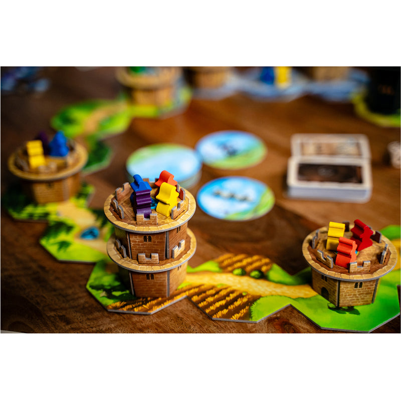 Load image into Gallery viewer, Wandering Towers Board Game - sample components shown including tower figures with meeples in different colors on top.
