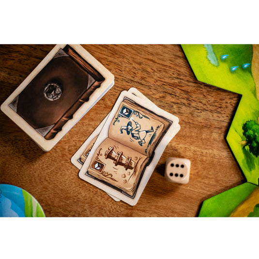 Wandering Towers Board Game - sample components shown including game card and d6 die.