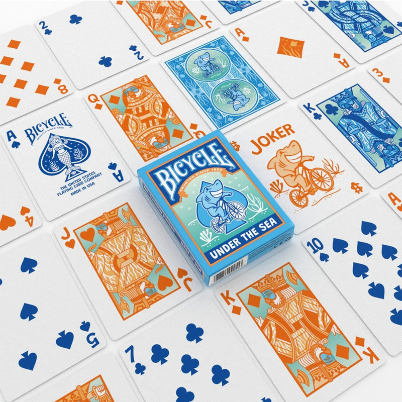 Load image into Gallery viewer, Bicycle Under the Sea Playing Cards - box and sample cards shown with face cards illustrated wearing scuba masks. 
