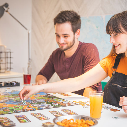 Small World Board Game - Lifestyle image of people playing Small World game.
