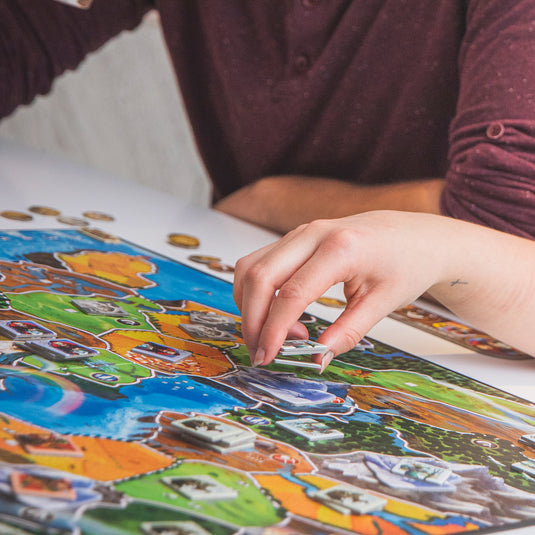 Small World Board Game - Lifestyle image of people playing Small World game.