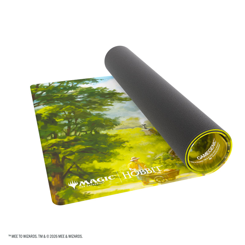 Load image into Gallery viewer, Magic: The Gathering | The Hobbit Prime Playmat - View of partially rolled up playmat with Magic the Gathering and The Hobbit branding in the corner. 
