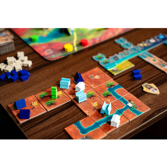 Papyria Board Game - Sample game components shown including map tiles and meeples in a variety of colors. 