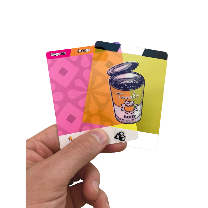 Load image into Gallery viewer, Pop Art Card Game - View of person holding a 'Magenta/orange' card and a yellow translucent tomato soup card. 
