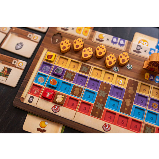 Kingdom Crossing Board Game - Player board shown with orange paw print tokens and resource tokens. 