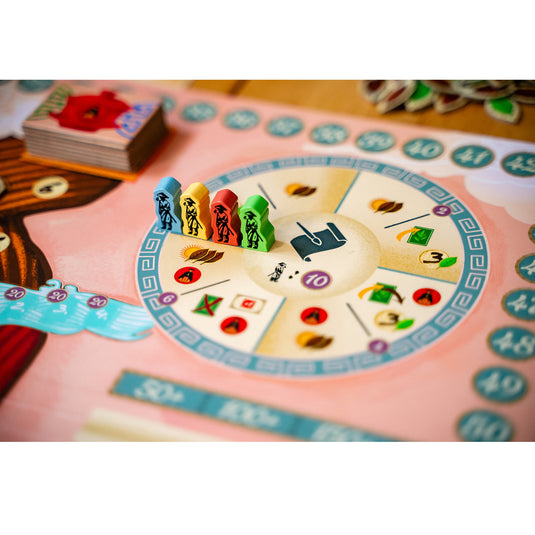 Tea Garden Board Game - sample character meeples shown in blue, yellow, red, and green on top of game board.